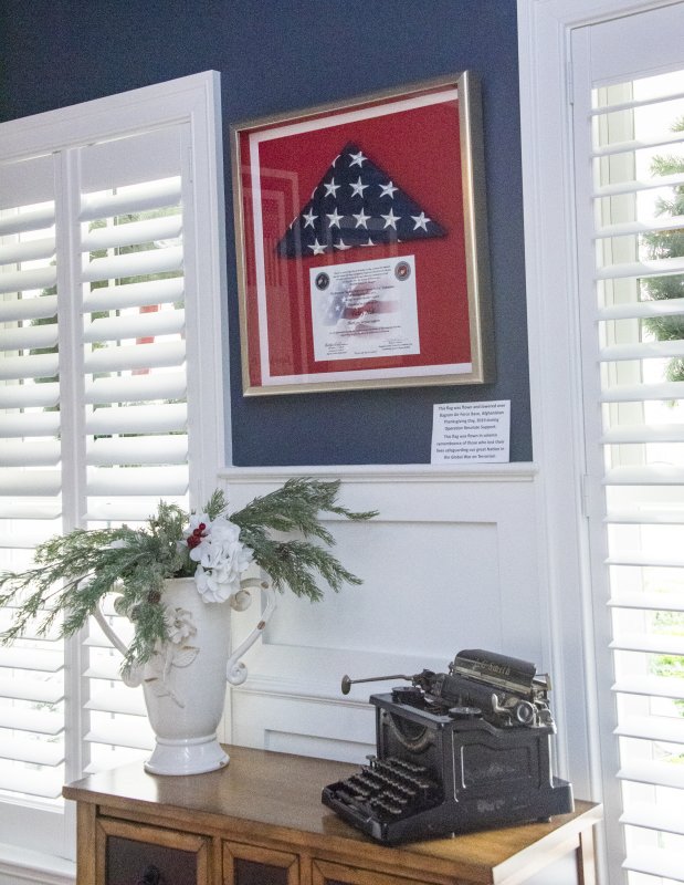The study wall in Patty and Greg Null’s home on Crossrail Way frames a memento of Greg’s years on President George H.W. Bush’s Secret Service detail.